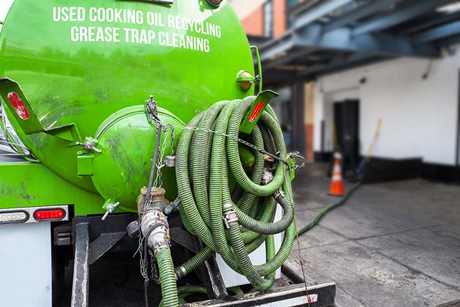 a service truck pumping grease from a restaurant's grease trap in Yonkers